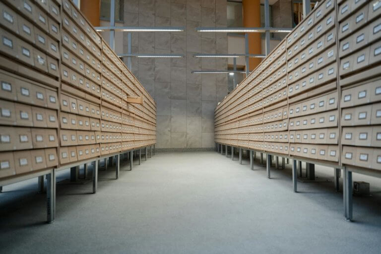 a gray room with shelves full of brown drawers