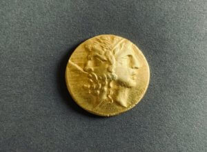 ancient golden coin on dark background