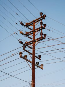 low angle shot of transmission tower with electric lines