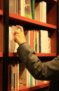 hand browsing books at library