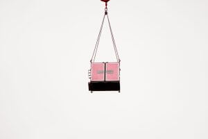 suspended cargo container against minimalist sky