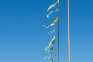 colorful flags waving against clear blue sky